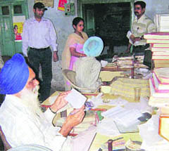 Staff at Ahmedgarh post office work in dark during power cut