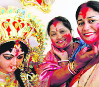 Women take part in Sindur Utsav before the immersion of Durga idols in Chandigarh on Thursday.