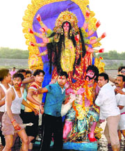 Devotees immerse an idol of Durga in the Ghaggar river in Panchkula on Thursday.