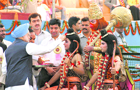 Prime Minister Manmohan Singh applies tilak on Ram as Lakshman and Hanuman look on during Dussehra celebrations at Subhash Maidan in New Delhi on Thursday.