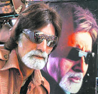 Javed Khan, a lookalike of Big B, poses next to a poster of the actor in Bhopal as a tribute on the latter’s 66th birthday.