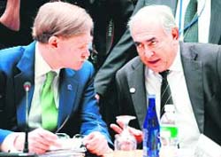 World Bank president Robert Zoellick (L) and IMF managing director Dominique Strauss-Kahn speak before the start of a meeting of the Development Committee during the International Monetary Fund/World Bank meetings on Sunday at the World Bank in Washington.