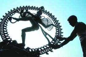 A labourer cleans the idol of Natraja before placing it for display in the forthcoming Tamil Nadu festival in Leisure valley, Sector 10, Chandigarh