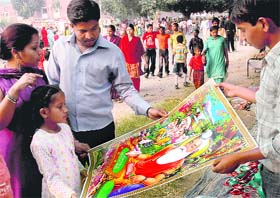 Devotees buy posters on the occasion of Valmiki Jayanti in Sector 24, Chandigarh