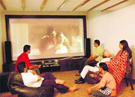 MC councillor Devinder Singh Babla and his family enjoy a flick on their home theatre