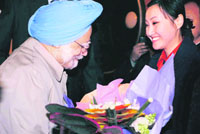 Prime Minister Manmohan Singh being presented a bouquet by a Chinese girl upon his arrival at Beijing airport on Thursday.