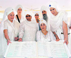 Gur Amrit Kaur (sitting) with the Spanish translation of Guru Granth Sahib at Hazur Sahib on Sunday.