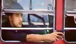 In this image taken from a news channel, Rahul Raj, 23, points a handgun from the window of a bus in Bail Bazaar area of Kurla, a north-east suburb of Mumbai, on Monday morning.