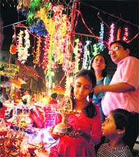 A family buys an electric lamp on the eve of Diwali in Ludhiana