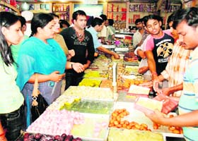 People buy sweets on the eve of Diwali at Model Town