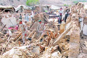 Pakistani soldiers inspect collapsed houses in Ziarat, about 50 km north of Quetta
