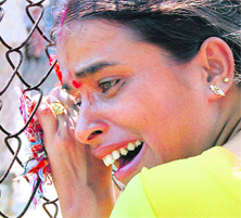 A woman cries after hearing the news of her husband's death in one of bomb blasts, outside a hospital in Guwahati on Friday.