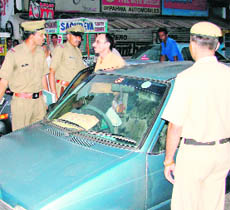 Police personnel challan traffic violators during a drive in Ambala.