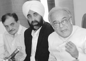 Ashim Dasgupta, chairman of the Empowered Committee of Finance Ministers, interacts with mediapersons after chairing the meeting of finance ministers at Chandigarh