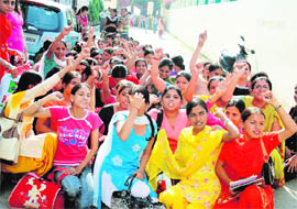 Students protest the recent fee hike at Guru Nanak Girls College in Model Town, Ludhiana, on Tuesday.