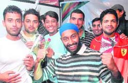 The Lions strike a pose with roses at the inauguration of the new high resolution video and music sections of SantaBanta.com at Voodoo-26 on Tuesday evening