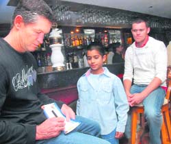 An ICL player signs an autograph for a cricket fan at the venue.