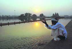 SPIRITUAL QUEST: A devotee offers prayers on the banks of Brahmsarovar in Kurukshetra.