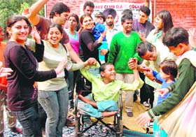 A physically challenged inmate of Mother Teresa's Home in Sector 23 (Missionaries of Charity) enjoys with members of the Rotract Club of DAV College on the eve of Children’s Day in Chandigarh