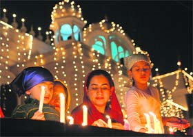 Devotees light candles on the occasion of Gurparb at a gurdwara in Chandigarh