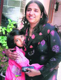 Seema, wife of Capt Prabhat Kumar Goyal, hugs her daughter after hearing the news of Prabhat's release, in Dehradun