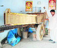 An artisan puts the finishing touches to a brass-plated cart in Gangwa village, near Hisar.