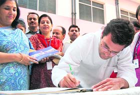 Rahul Gandhi signs the visitors book at DAV Public School in Amritsar