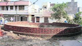 One of the water reservoirs of Ambala City, which was used for dumping garbage, is being repaired