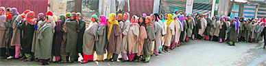 Women wait in a long queue outside a polling station at Lar to cast their vote during the second phase of the Jammu and Kashmir assembly elections in Ganderbal district, some 40 km from Srinagar, on Sunday.