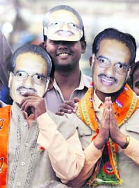 BJP workers wear masks of Madhya Pradesh Chief Minister Shivraj Singh Chouhan during an election rally in Vidisha district, about 56 km from Bhopal