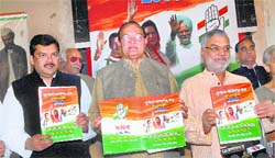 Former state Congress president B.D. Kalla along with Pradesh Congress Committee chief C.P. Joshi and Mukul Wasnik (left) during the launch of the state election manifesto in Jaipur on Tuesday.