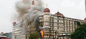 Smoke and flames billow out of the Taj Mahal hotel during its rescue operation in Mumbai on Saturday. 