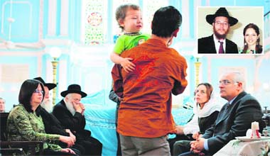 Jewish toddler Moshe, aged 2, who lost his parents US Rabbi Gavriel Holtzberg and his Israeli wife Rivkah (inset), when terrorists staged an assault on a Jewish centre last week, is held by an unidentified Indian man during a prayer meeting at the Keneseth Eliyahoo Synagouge in Mumbai