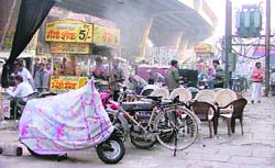 Encroachments have reduced space for the movement of traffic; and (right) shopkeepers have also extended their shops in Chaura Bazar in Ludhiana.