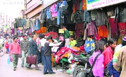 Encroachments have reduced space for the movement of traffic; and (right) shopkeepers have also extended their shops in Chaura Bazar in Ludhiana.