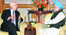 US Senator John McCain talks to Prime Minister Manmohan Singh in New Delhi on Tuesday.