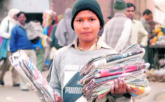 No plastic smile, here. A little boy selling bags made of newspapers at Sector 26, Chandigarh