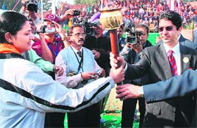Olympic gold medallist Abhinav Bindra hands over the game torch during the 17th All-India Forest Games and Sports Meet that started on Panjab University grounds