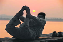 Early bird catches the posture. A man makes the most of the sunrise serenity at Sukhna Lake to practice his asanas on Wednesday