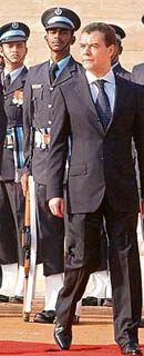 Dmitry Medvedev walks down a red carpet in Delhi.