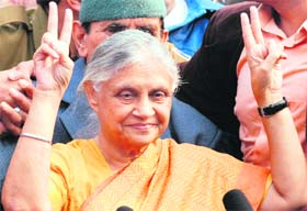 Delhi Chief Minister Sheila Dikshit flashes the victory sign after Congress won for the third time in the Delhi assembly elections