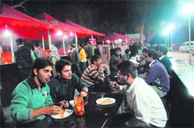 STREET SMART: Students enjoying paranthas at the Night Food Street-14 Photo: Pradeep Tewari