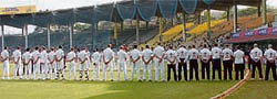 A soldier keeps watch as players observe a one-minute silence for victims of the Mumbai terror attacks before the start of the first Test between India and England at the MAC Stadium in Chennai on Thursday.