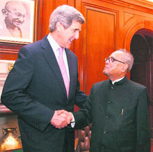 External affairs minister Pranab Mukherjee shakes hands with US Senator John Kerry during a meeting in New Delhi on Monday.