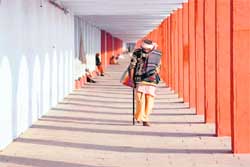 A sadhu walks in a corridor of Brahamsarovar in Kurukshetra.