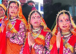 Girl students welcome guests at a function in Dehradun on Thursday.