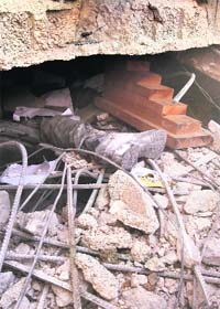 The leg of a Hamas policeman is seen in the rubble in Gaza