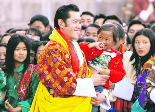 Bhutan’s King Jigme Khesar Namgyel Wangchuck carries a child in the courtyard of Tashichhodzong Palace during celebrations, marking his coronation ceremony in Thimphu on November 6 — Reuters