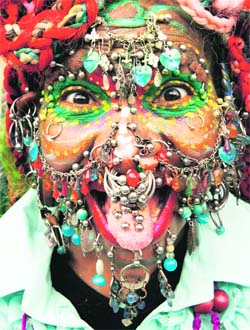 Guinness World Record holder for the ‘Most Pierced Woman’ Elaine Davidson, poses for a photograph in Edinburgh, Scotland, showing 5,920 piercings on May 16 — Reuters