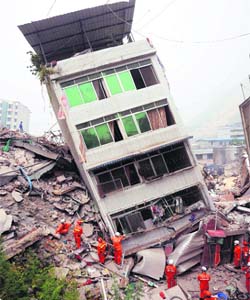 Rescuers search for survivors around a building in Beichuan, Sichuan province of China, on May 17. Workers saved more than 60 people from the rubble following a massive earthquake. The death toll was almost 30,000 — Reuters